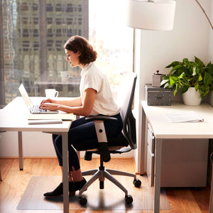 Picture showing a lady working at her desk while using the pvc protective floor  mat on wooden floor.