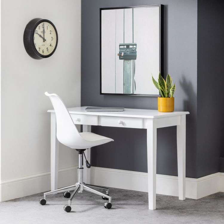 Picture of the white carrington lacquered pine home office desk  of how it would look in your home office with a plant and laptop on the desk.