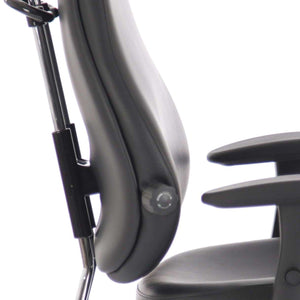 Side view of the black leather foam contoured backrest with dual curved chrome support posts.