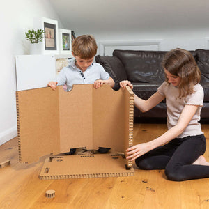 Showing 2 children putting together the eco easy home office desk in seconds.