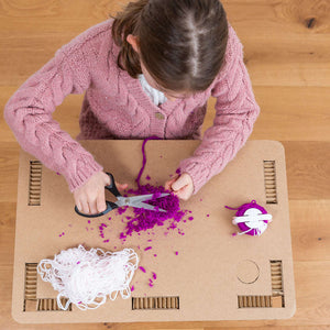 Showing a child using the eco desk for craft work .