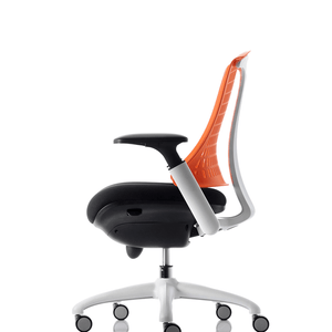 Side view of the white frame task operator chair with orange mesh back , with large fabric black cushioned seat.