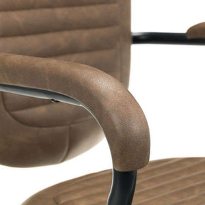 Close up of the brown faux leather padded armrest  with blackmetal frame ,of the gehry industrial retro home office chair.