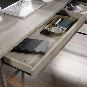 manhattan view l shaped mystic oak finish home office desk. close up of the drawer open of the l shape desk showing what items you can put in to it.