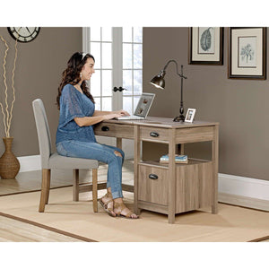 sit-stand home office desk in salt oak. close up sitting at the desk  with laptop.