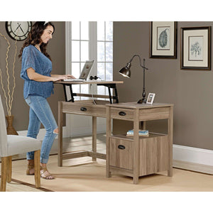 sit-stand home office desk in salt oak. showing standing at the desk if you prefer to stand and work.